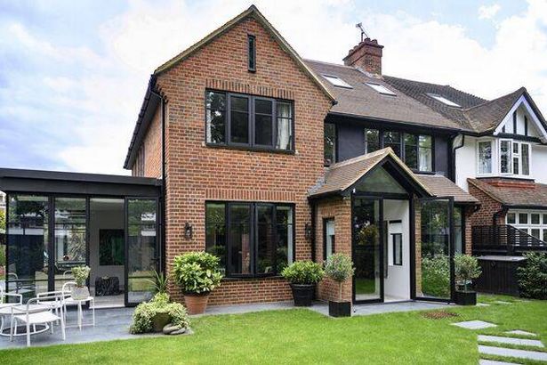 Semi-detached brick house in London with luscious lawn