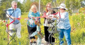 Jeff Stableford from Community Foundation, Mary Madden, vice president of Touch the Earth Garden Club, Grand Blanc City Manager Wendy Jean-Buhrer and Deborah Glasstetter, Touch the Earth president, cut the ribbon during a dedication ceremony for the new sculpture, Butterfly Dreams, in Center Pointe Garden. Photos by Lania Rocha