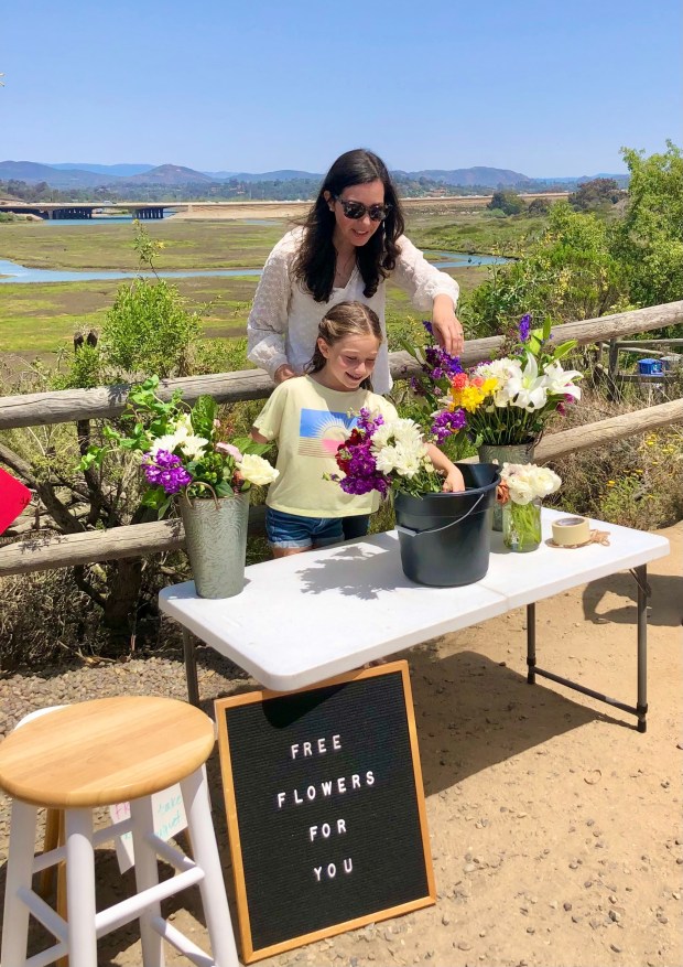 "Grown with Love" author Kelli Pease giving out free flowers on her birthday in Solana Beach. (Courtesy Kelli Pease)