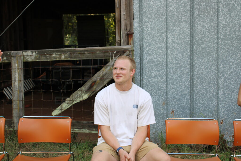 Owen Setterlind, UGArden Exec member, sits in front of barn prior to UGArden's weekly meeting.