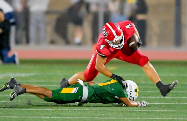 Quentin Pacelli (4) of Garden Grove manages to keep his...
