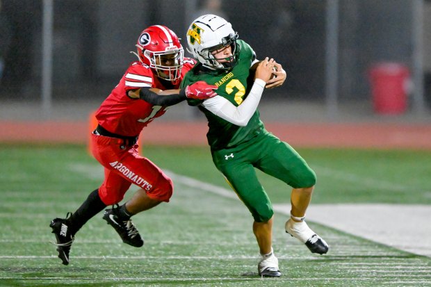 Jacob Vasquez (2) of Rancho Alamitos attempts to break free...