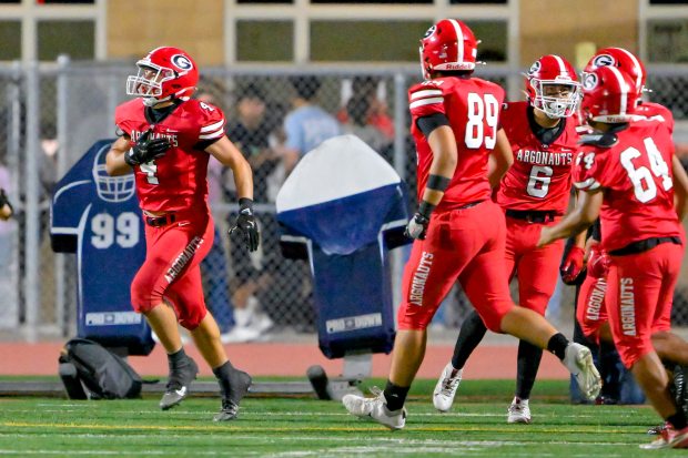 Quentin Pacelli (4), left, of Garden Grove celebrates after scoring...