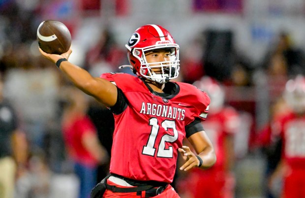 Garden Grove quarterback Calvin Keovphan (12) passes in a game...