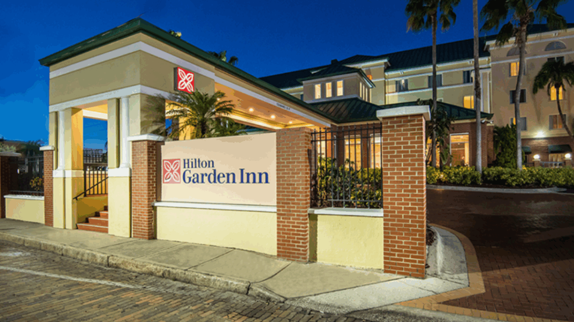 Exterior of the Hilton Garden Inn Ybor City in Tampa, Florida, photographed at night.
