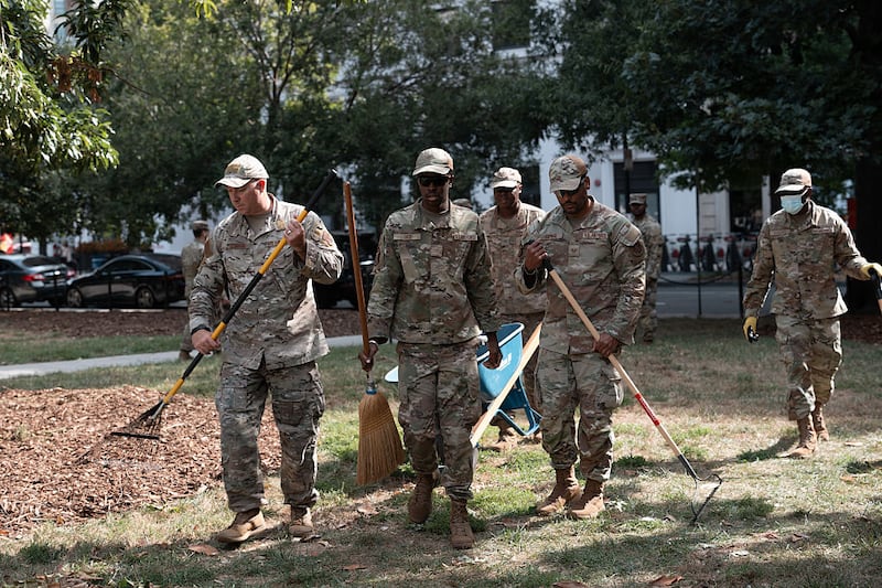 WASHINGTON, DC - AUGUST 28: Air National Guard airmen work clearing leaves and debris from McPherson Square Park on August 28, 2025 in Washington, DC. The Trump administration has deployed federal officers and the National Guard to the District in order to place the DC Metropolitan Police Department under federal control and assist in crime prevention in the nation's capital. (Photo by Andrew Leyden/Getty Images)