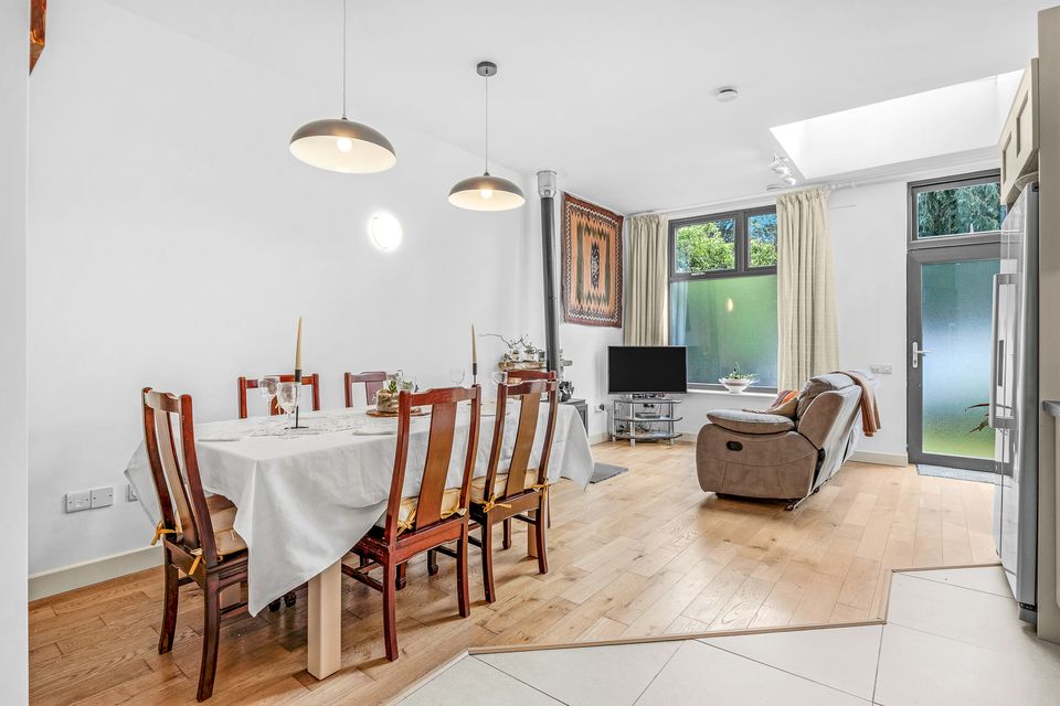 The open-plan living space, with a frosted window and door to the communal laneway