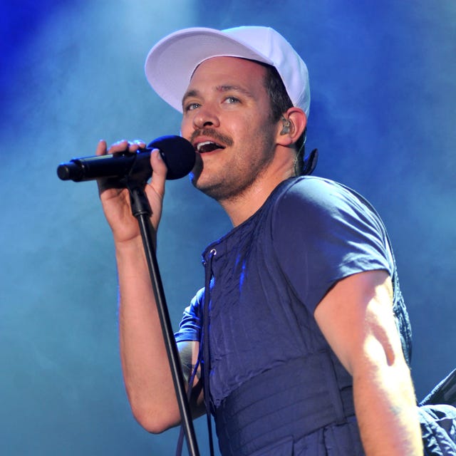 person performing on stage with a microphone in hand