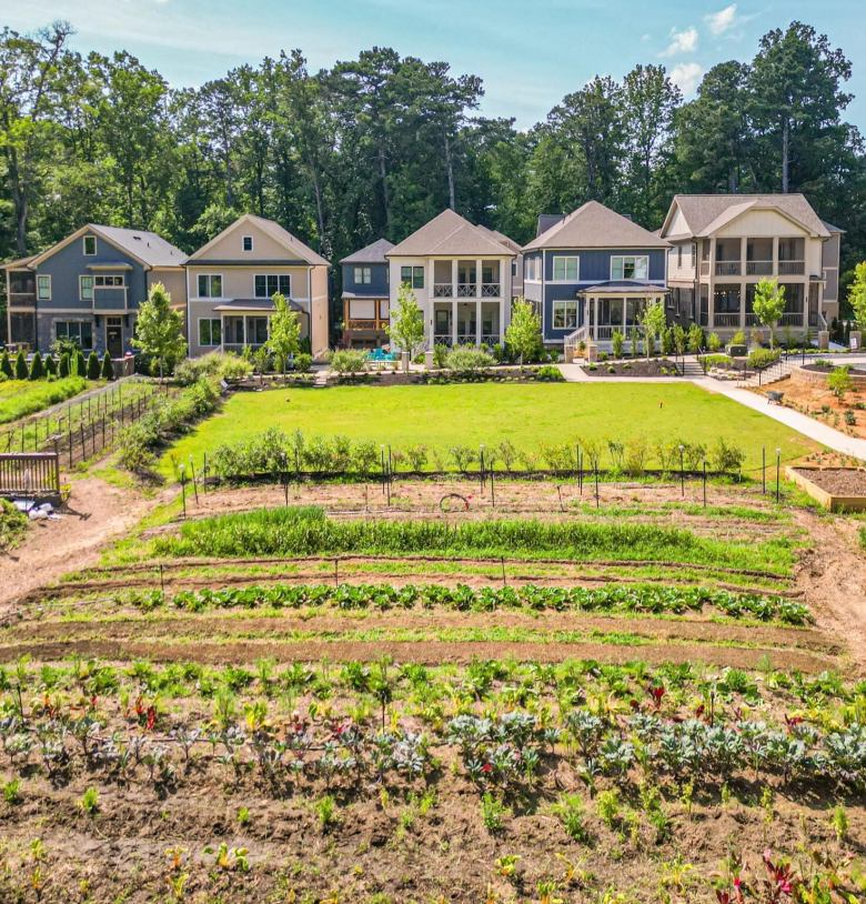 Drone shot overlooking the gardens with a stretch of five homes beyond it at Pendergrast Farm, a farm conservation community in the Briarcliff Woods neighborhood. (Provided by Pendergrast Farm)