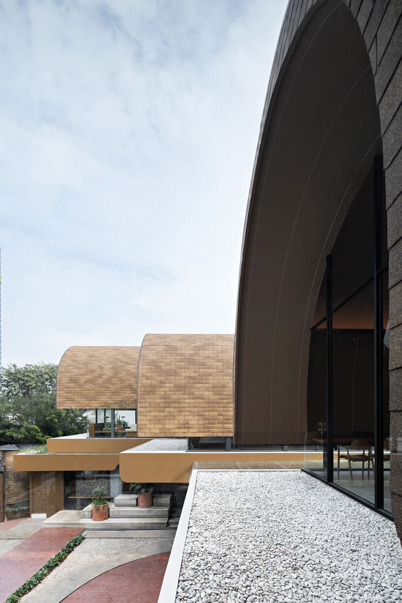 four arched shelters by RAD+ar expand upon layered sloped garden in north jakarta