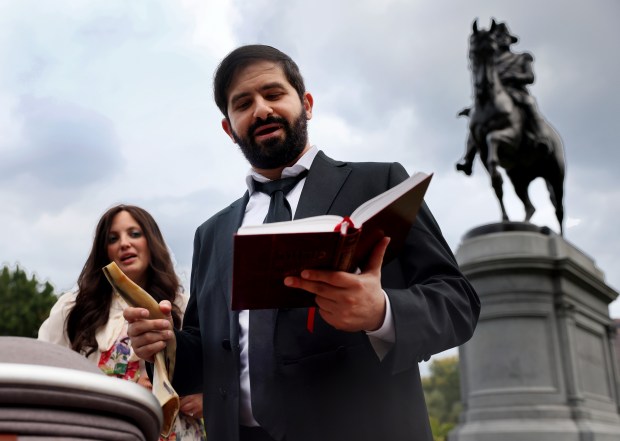 Central Synagogue Boston's Rabbi Mayer Zarchi reads from the machzor, a prayer book for the holiday, before blowing a shofar in the Public Garden on Rosh Hashanah. (Nancy Lane/Boston Herald)