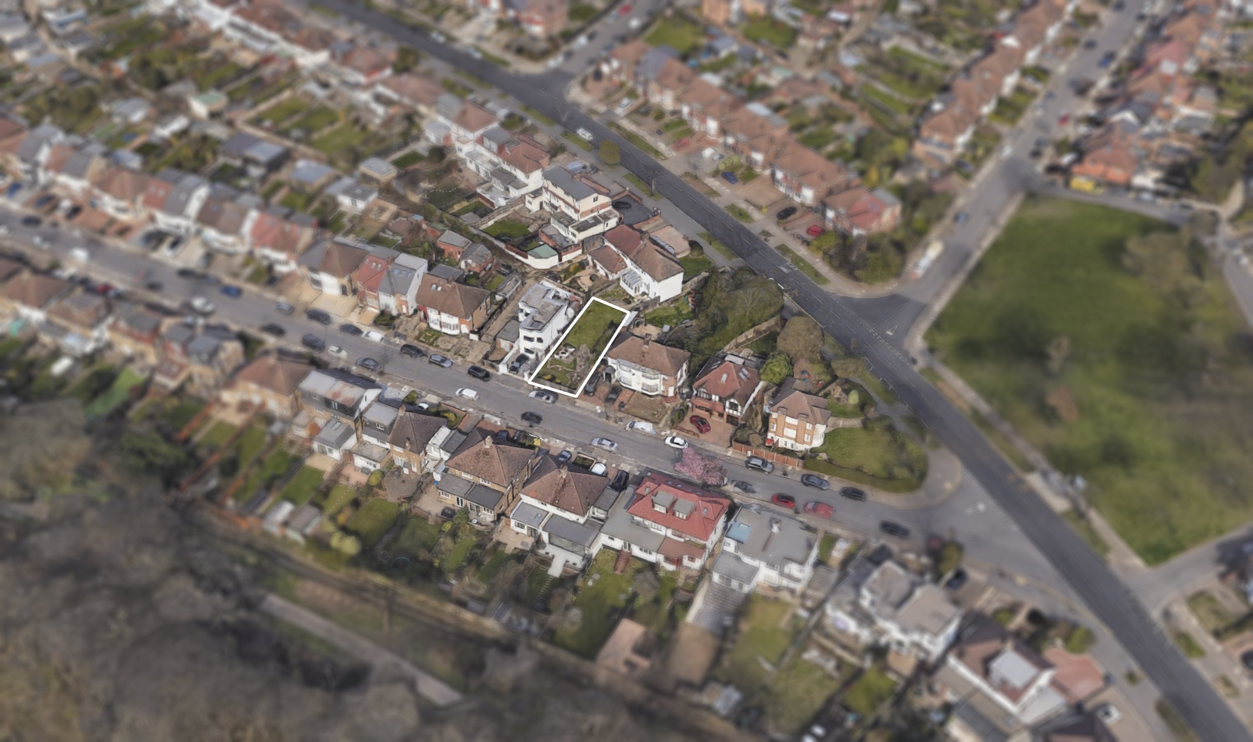 Aerial photo showing a highlighted house and its long, narrow garden extending to another street in a residential neighborhood.
