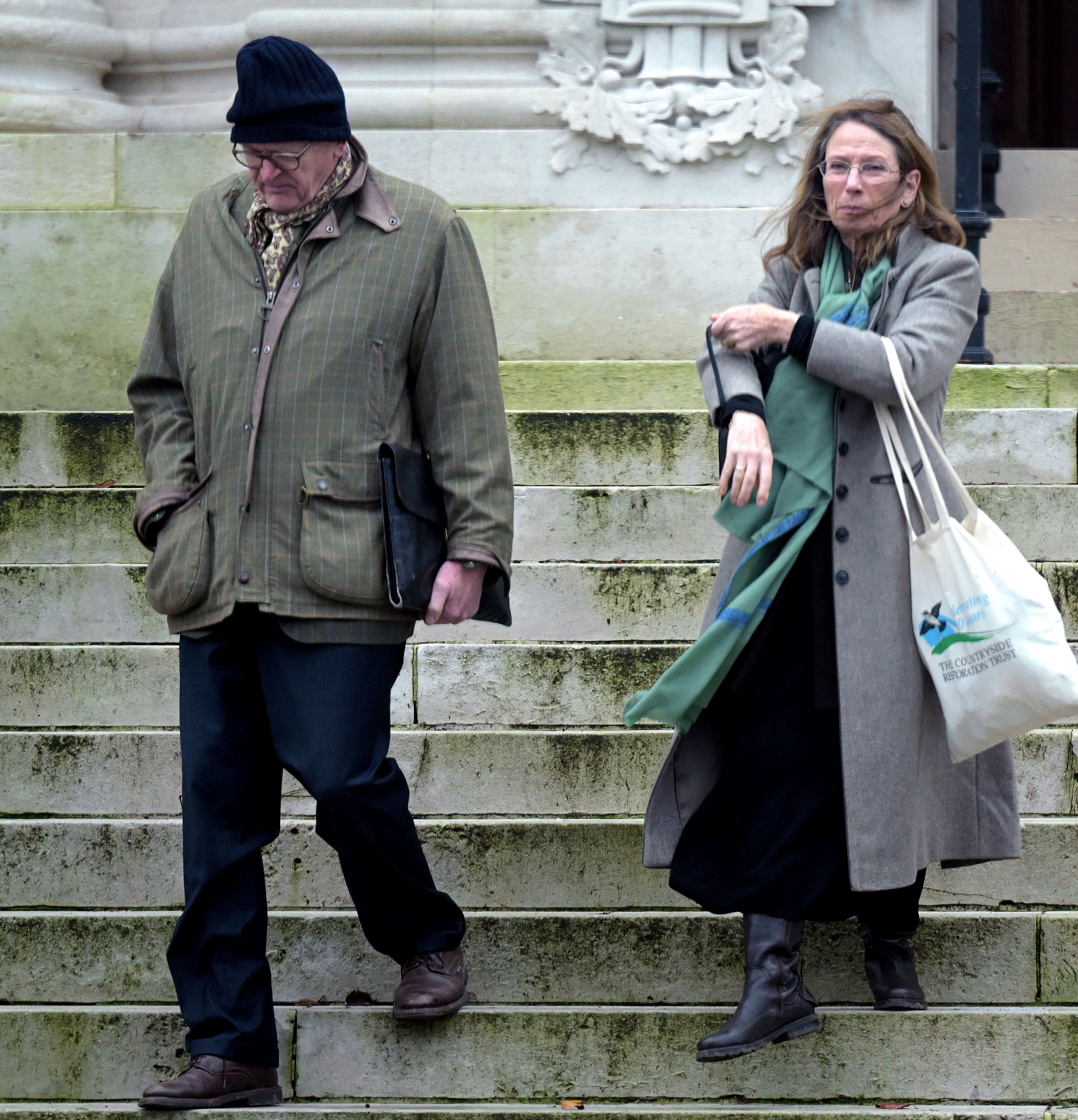 Nicholas and Anthea Prest descend stone steps.