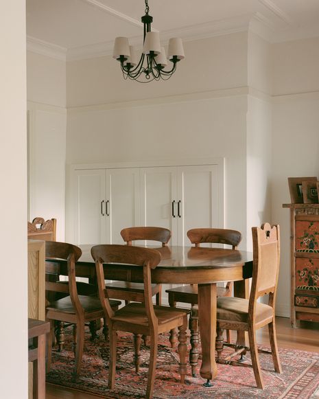 The former kitchen has been converted into a dedicated dining area, opening up in three directions to facilitate flow between social spaces.