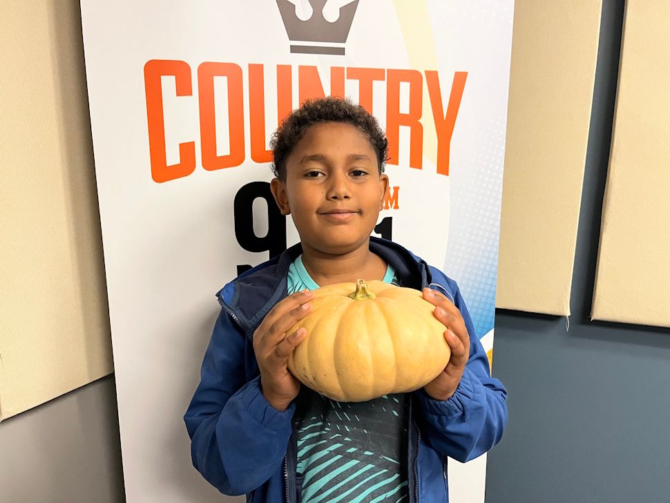 Isaiah Oke, 11-year-old Portage student, holding a pumpkin at Country 93 studios.