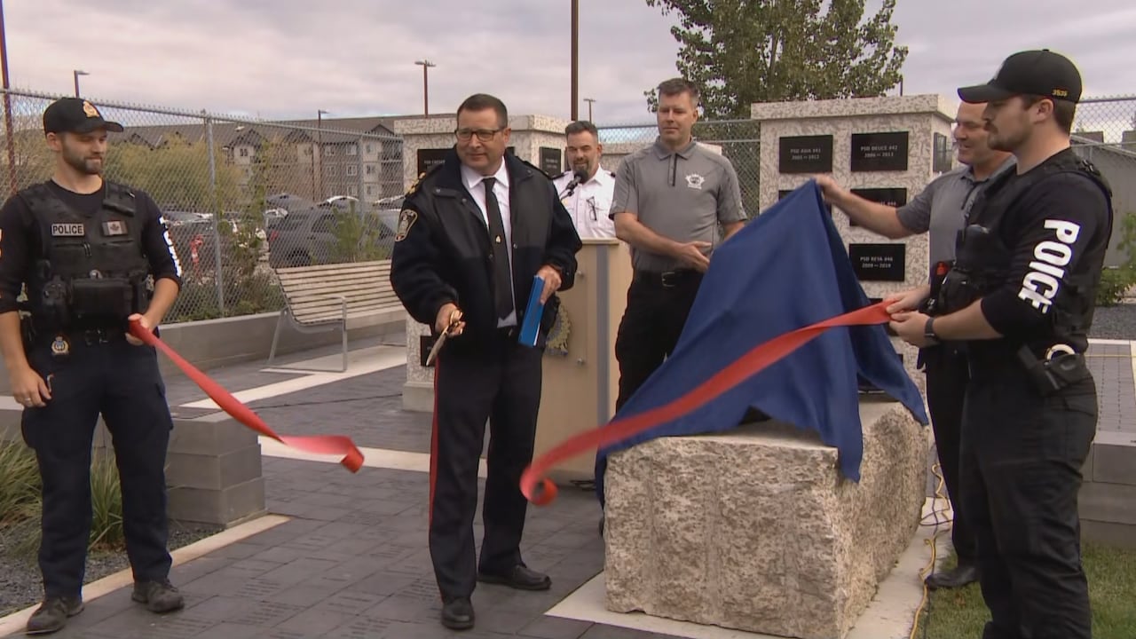 A man cuts a red ribbon 