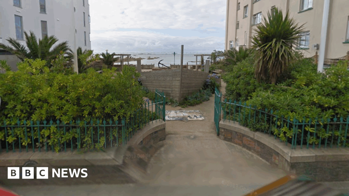 St Helier parish agrees to buy Allix’s Shipyard garden for £1 A picture of Allix's Shipyard. There is a number of plants and a wooden boat pictured in the yard. There is a body of water in the distance. There is two large buildings either side of the yard.