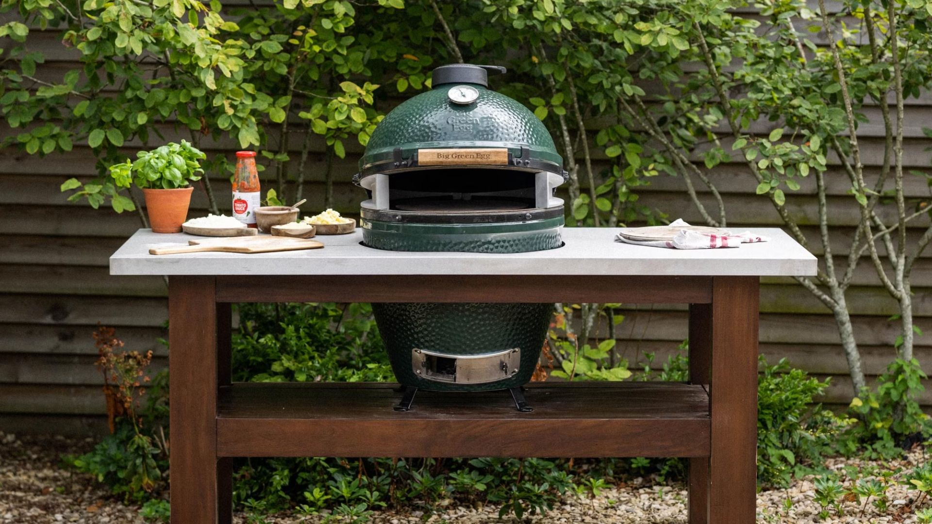 A Big Green Egg in a wooden stand