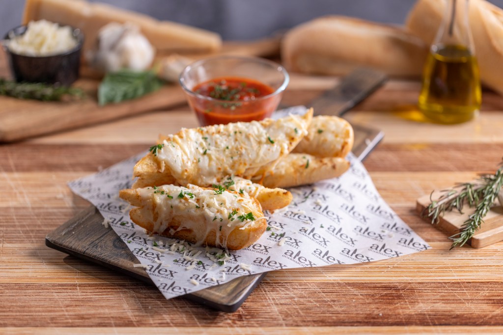 A plate of garlic bread and dipping sauce
