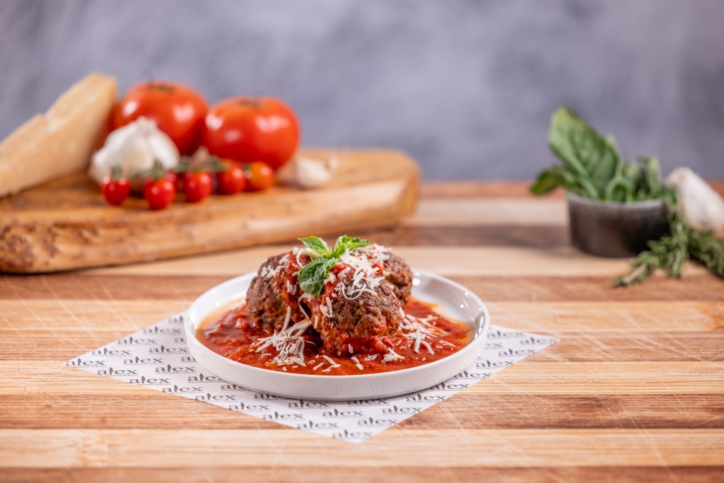 A plate of three meatballs