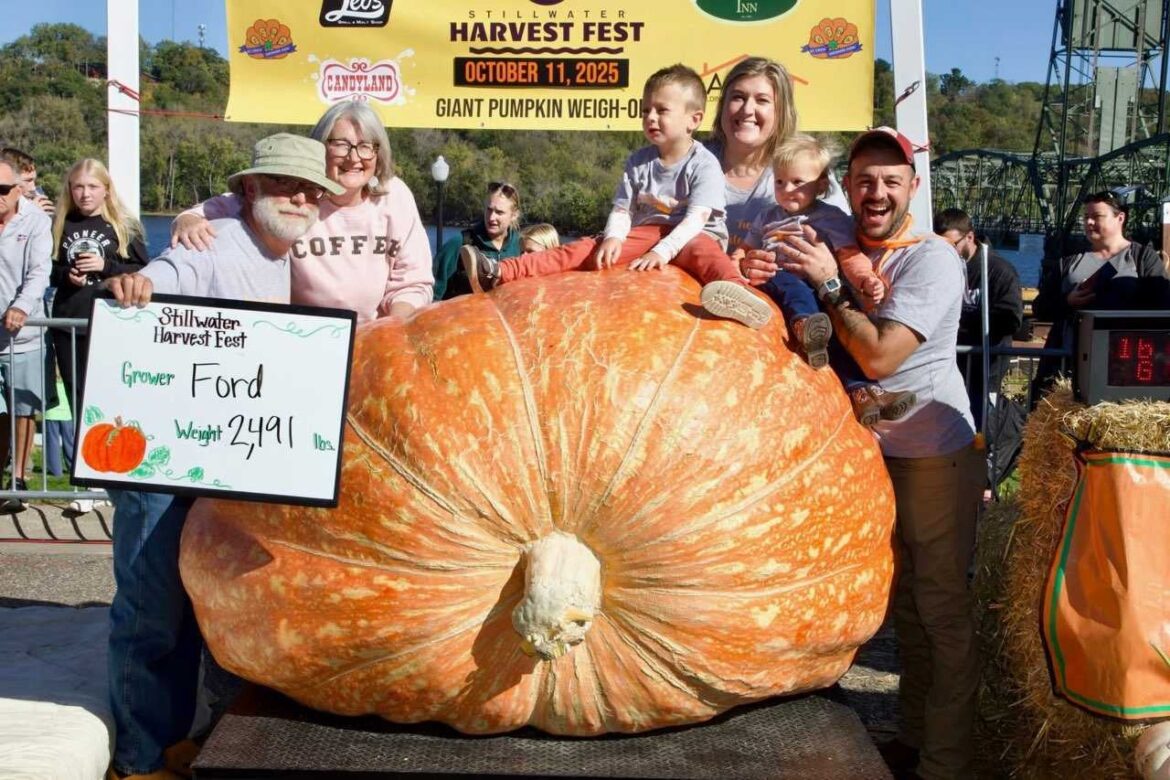 ‘I’m still a boy playing in the dirt’: Wisconsin gardener on decades of growing giant pumpkins A group of people poses with a giant pumpkin weighing 2,491 lbs at a harvest festival pumpkin weigh-off, holding a sign with the growers name and weight.