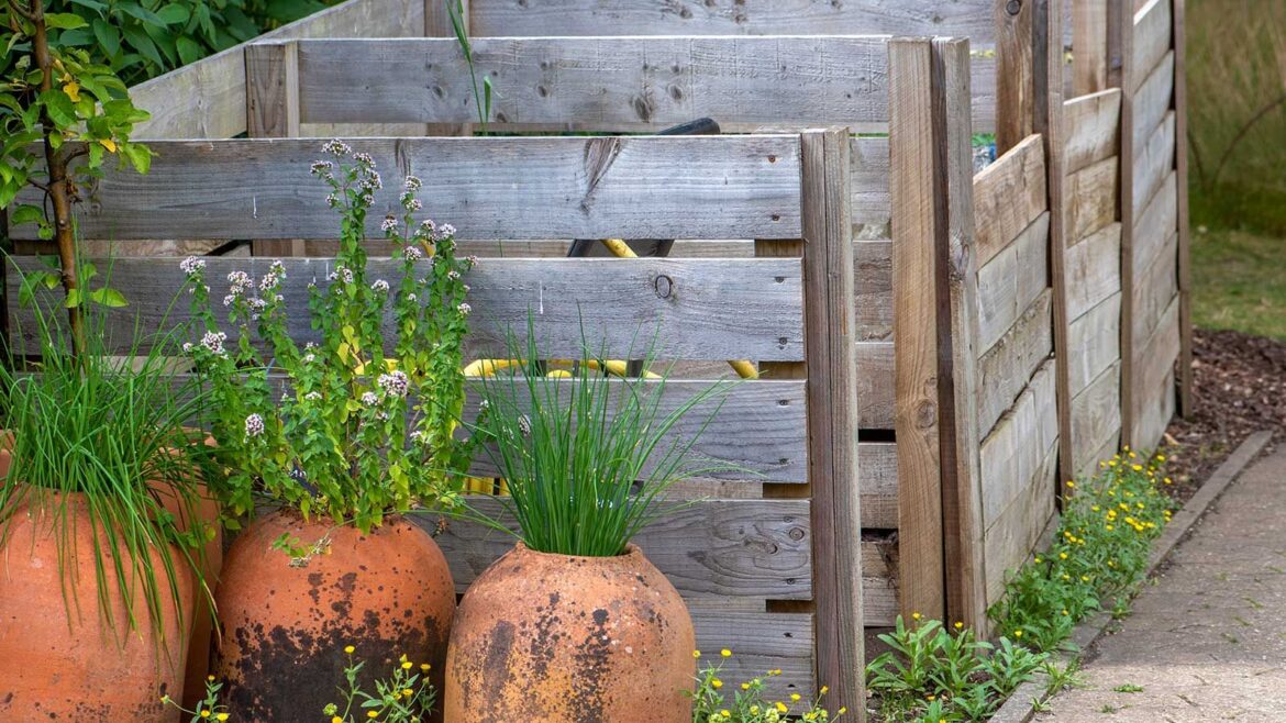 Composting made stylish: chic ways to compost this fall wooden compost bins with pot plants