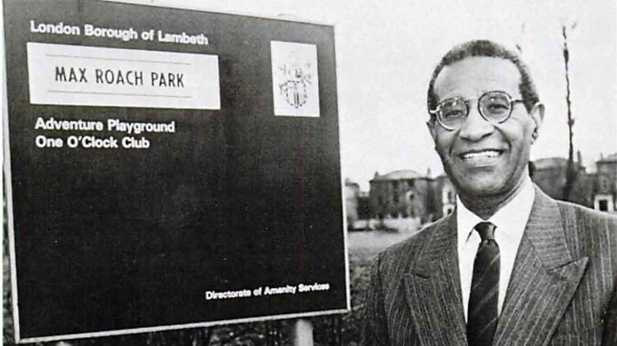 man standing next to public notice