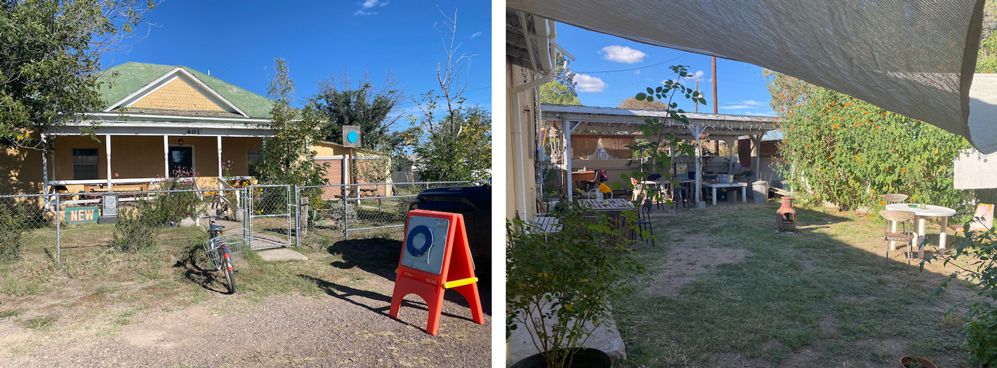 A yellow and green house with a bright orange sandwich board outside, paired with a view of a yard garden with tables & chairs.