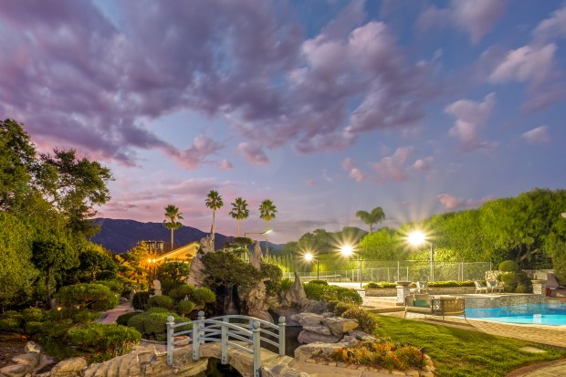 A view of the Asian-inspired garden, pool and LED-lit tennis...