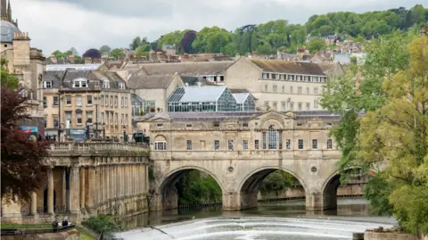 getty A view of Bath showing the weir and Pulteney Bridge with many bath stone buildings in the background