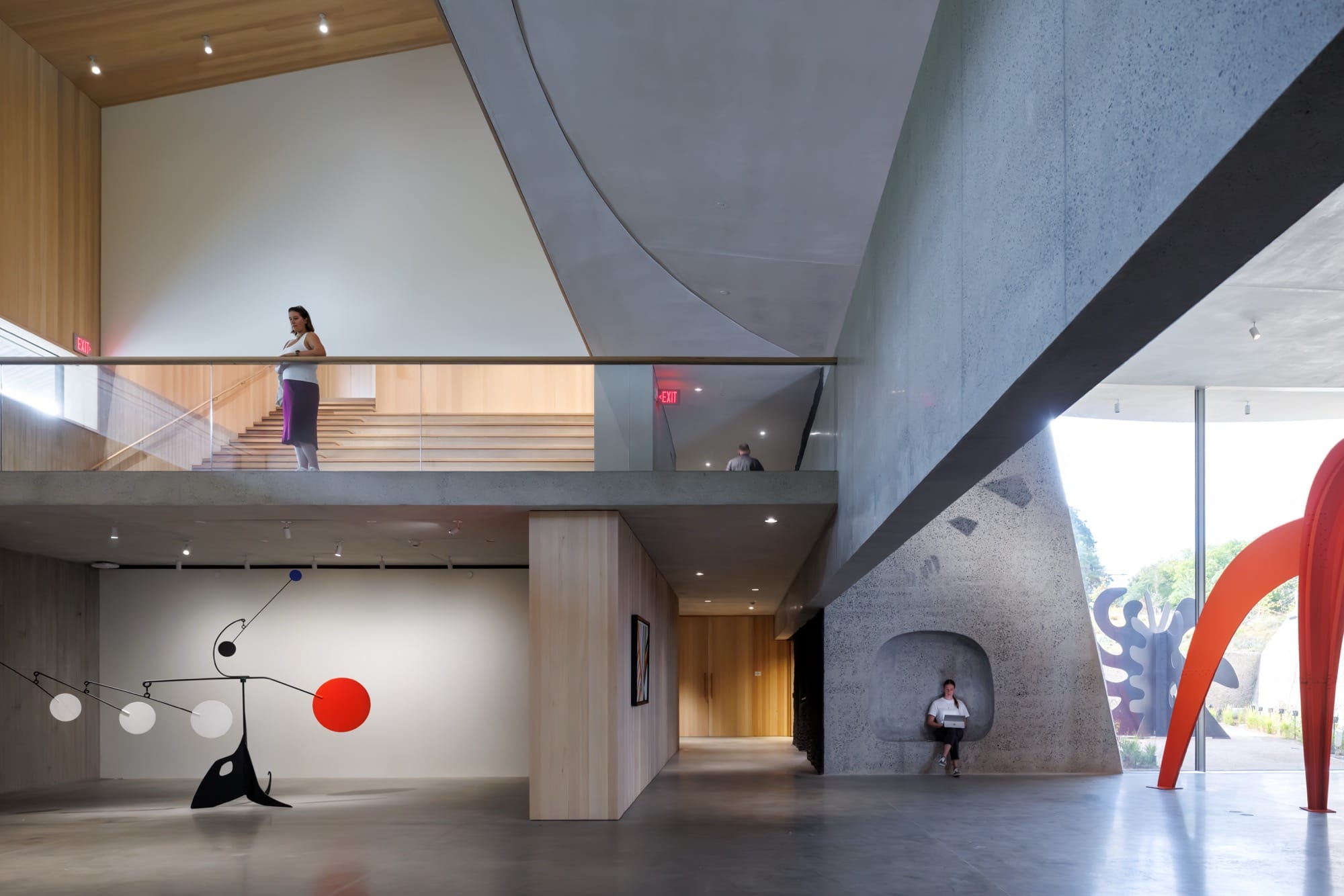 the open atrium at Calder Gardens with two large-scale sculptures in red and black and a large hanging mobile
