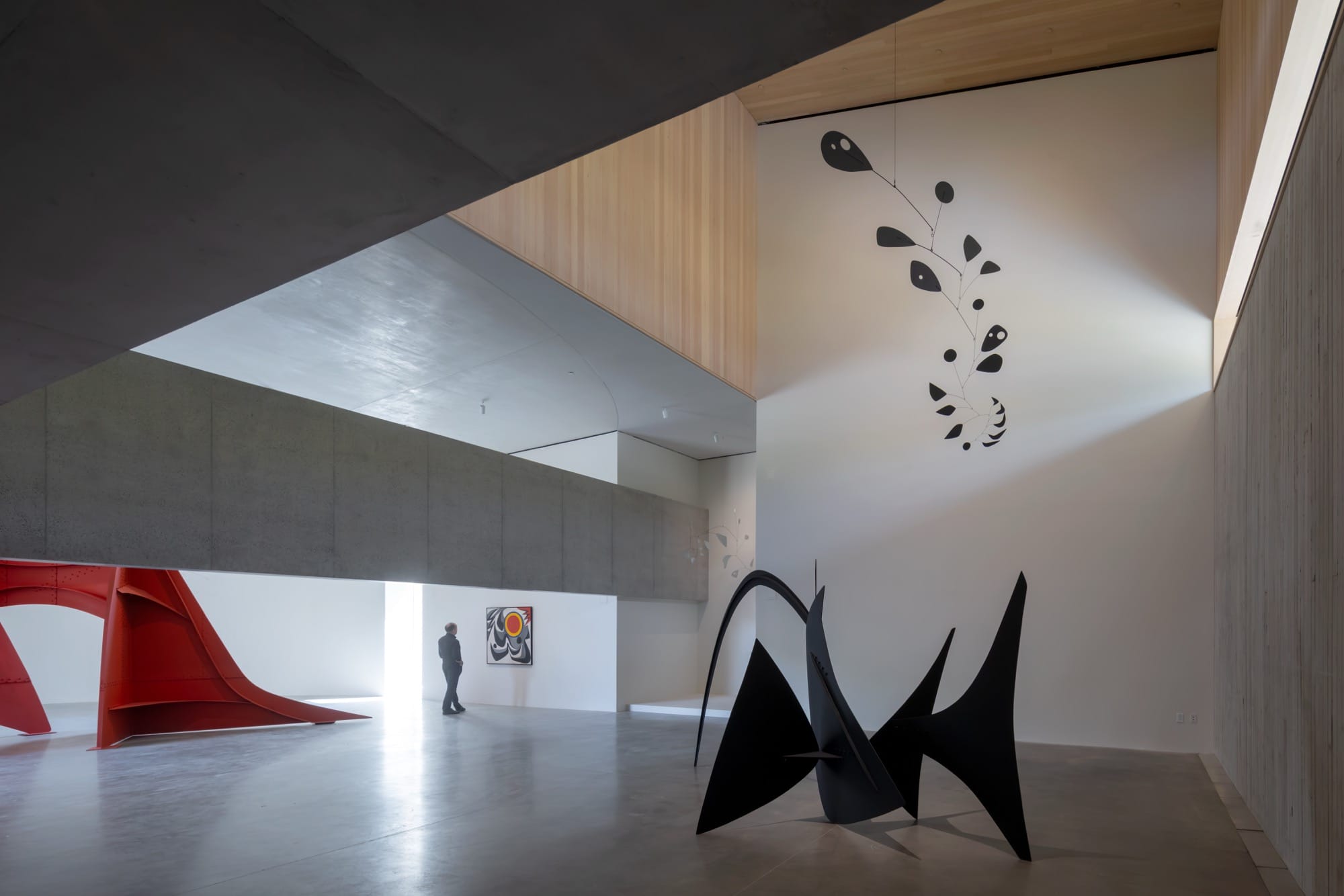 the open atrium at Calder Gardens with two large-scale sculptures in red and black and a large hanging mobile