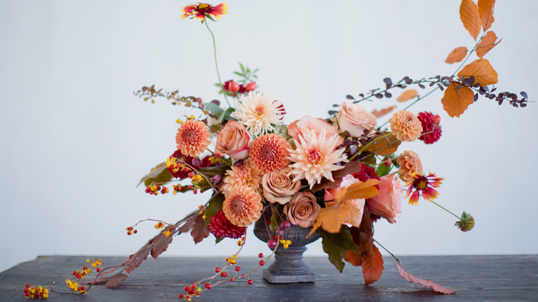 Autumn flower arrangement with berries, leaves, and flowers
