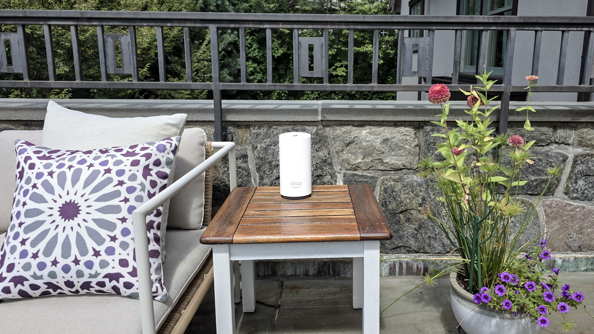 TP-Link Deco BE65-Outdoor on a garden table