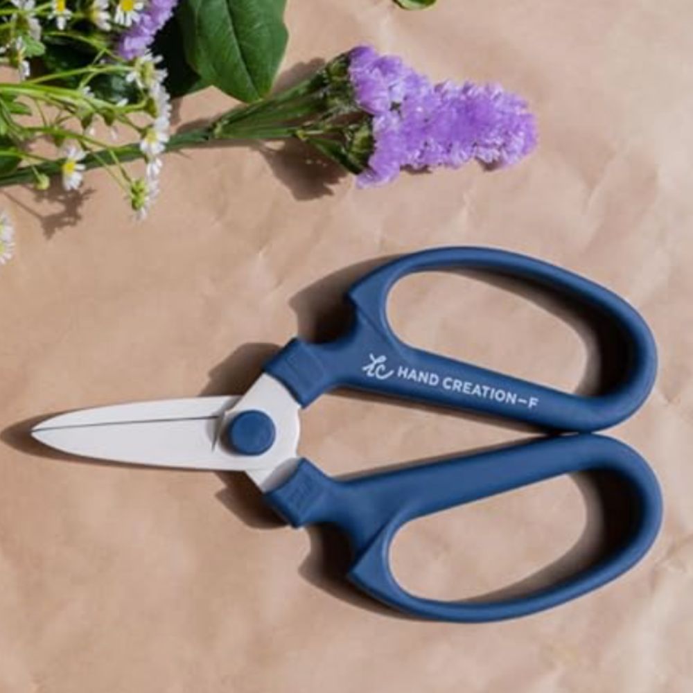 blue handled florist's scissors on brown paper