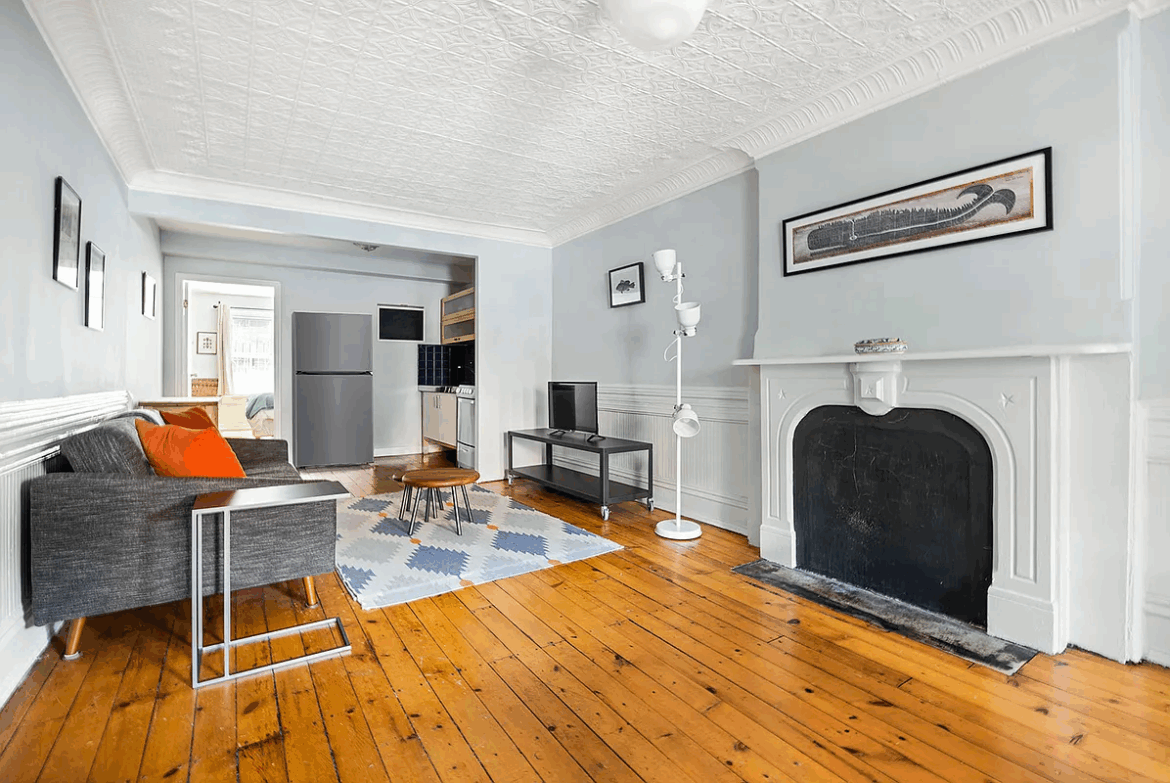 Park Slope Garden Unit Asks $2,995 a Month living room with wood floor, tin ceiling, marble mantel