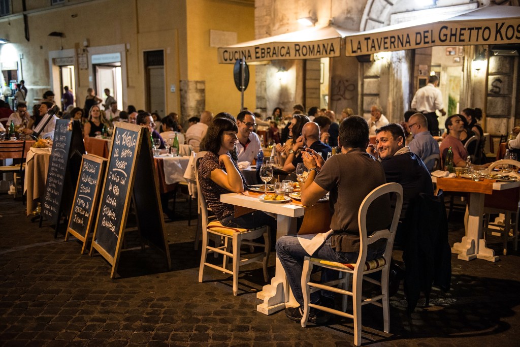 People eating at an outdoor Jewish restaurant in the Ghetto district of Rome.