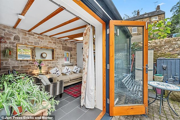 The pokey 506 sq ft pad has a cosy lounge and kitchen combined in one room, complete with an oven, hob, sink, washing machine and refrigerator