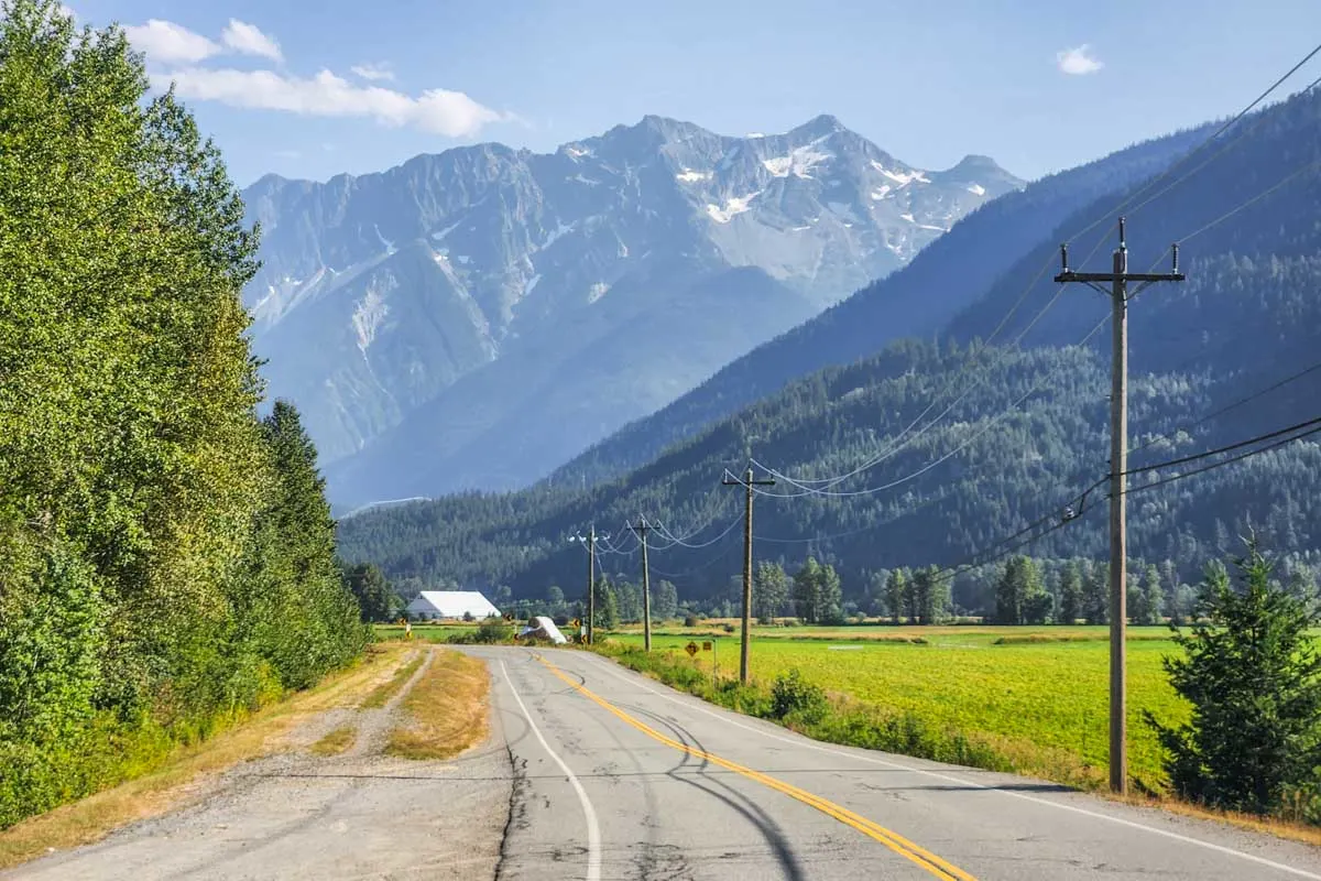 A rural road with Mt Currie in the background