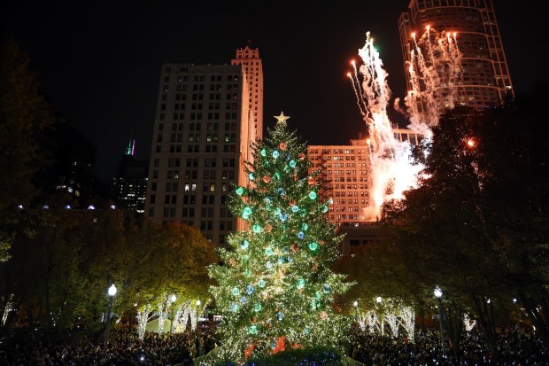 Fireworks erupt over Chicago's 112th official Christmas tree at the lighting ceremony, Nov. 21, 2025, in Millennium Park. The 68-foot Norway spruce was felled from a Glenview family's front yard. (Terrence Antonio James/Chicago Tribune)