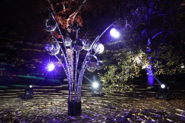 Disco balls shimmer from spotlights at an installation in the...