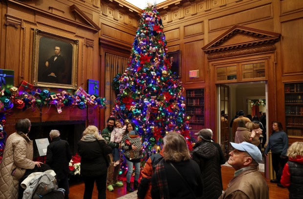 A large Christmas tree is on display as people tour...