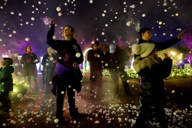Ally Tyer, 11, of Winfield, admires the fog bubbles floating...