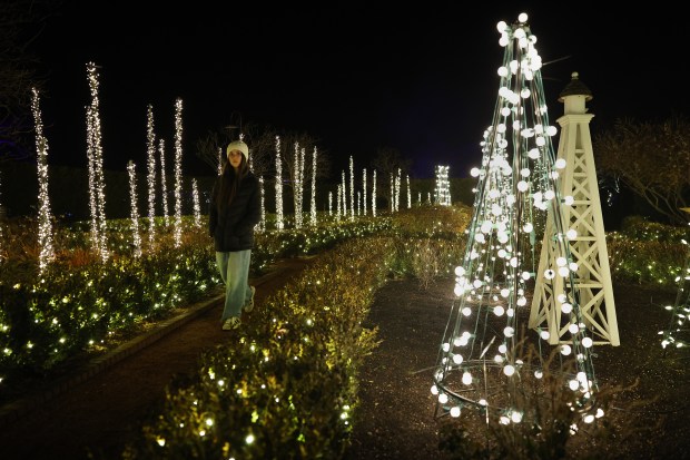 A guest walks the grounds decorated for the holidays while...
