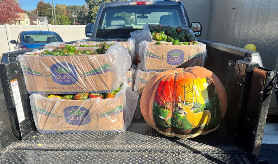 Boxes of fresh produce in the cab of a truck.