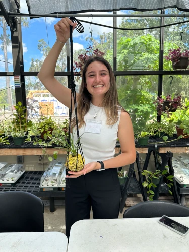 gardener holding Japanese moss ball. 