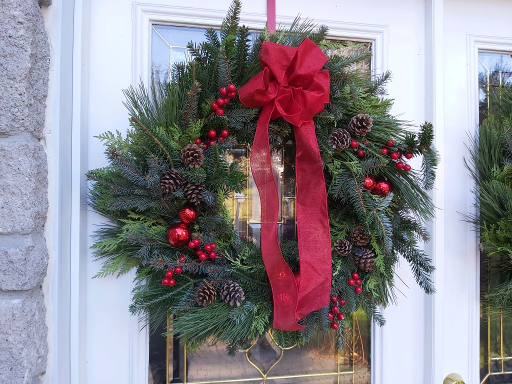 A wreath hangs on a door.