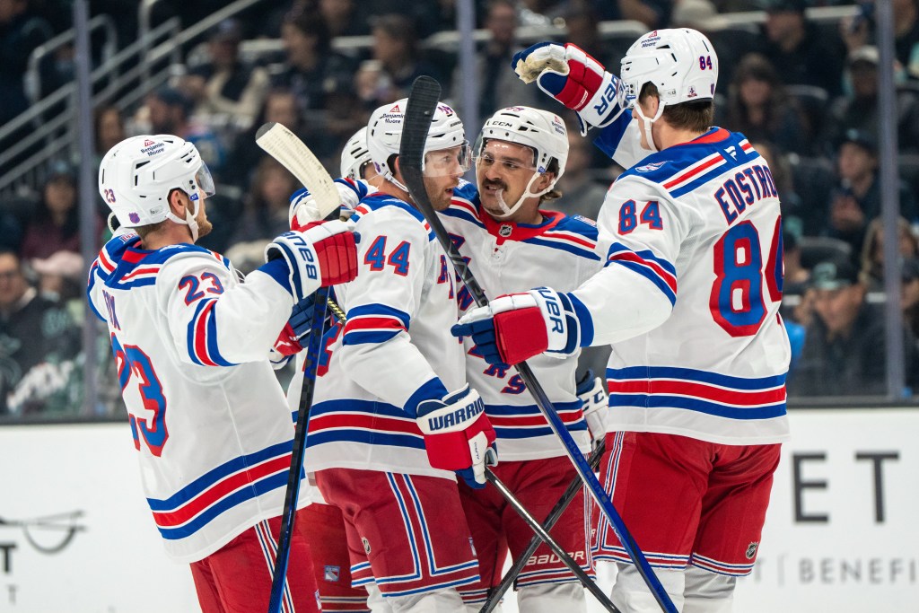 New York Rangers defenseman Vladislav Gavrikov (44), forward Sam Carrick, second from right, defenseman Adam Fox (23) and forward Adam Edstrom (84) celebrate a goal during the first period of an NHL hockey game against the Seattle Kraken, Saturday, Nov. 1, 2025.