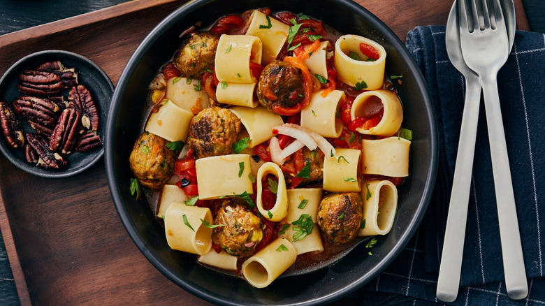 paccheri in a bowl with meatballs and nuts