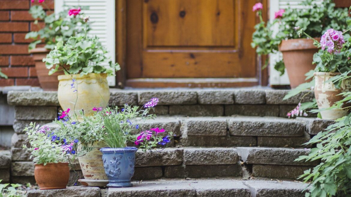 Why and how to keep plants safe with pot feet in winter Plants in containers on steps outside a front door